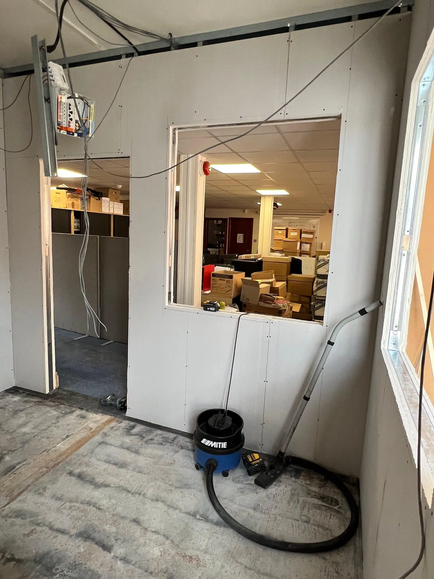 A room that is being remodeled with a vacuum.