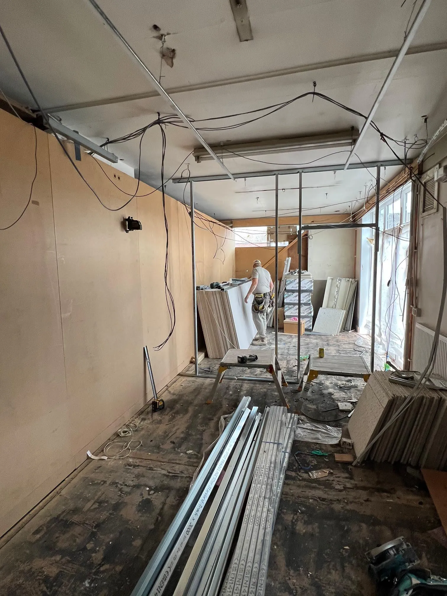 A room that is being remodeled and filled with items.