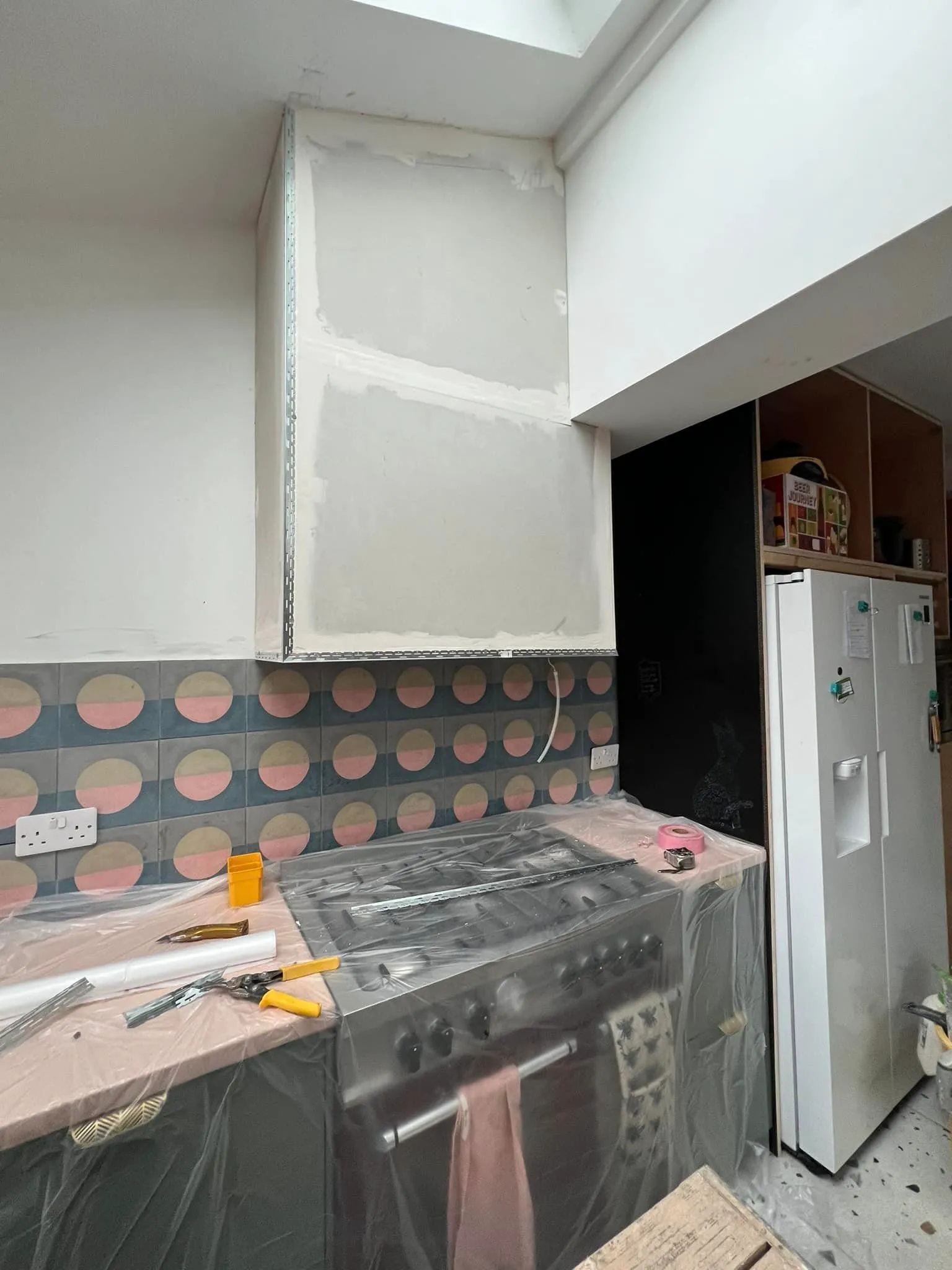 A kitchen with a stove and a refrigerator.